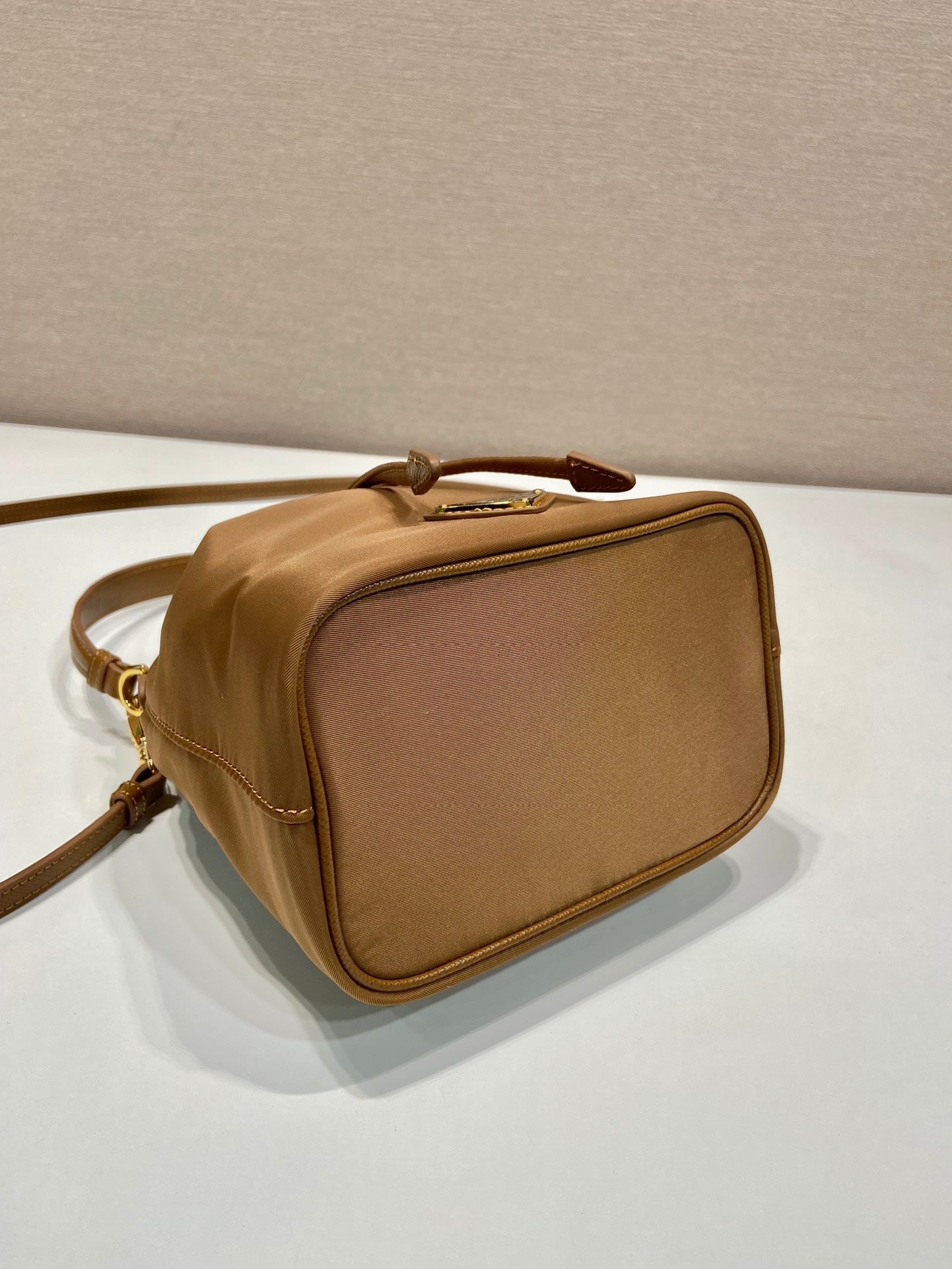 PRADA BUCKET BAG 19 IN RUSSET BROWN RE-NYLON AND CALFSKIN HANDLE