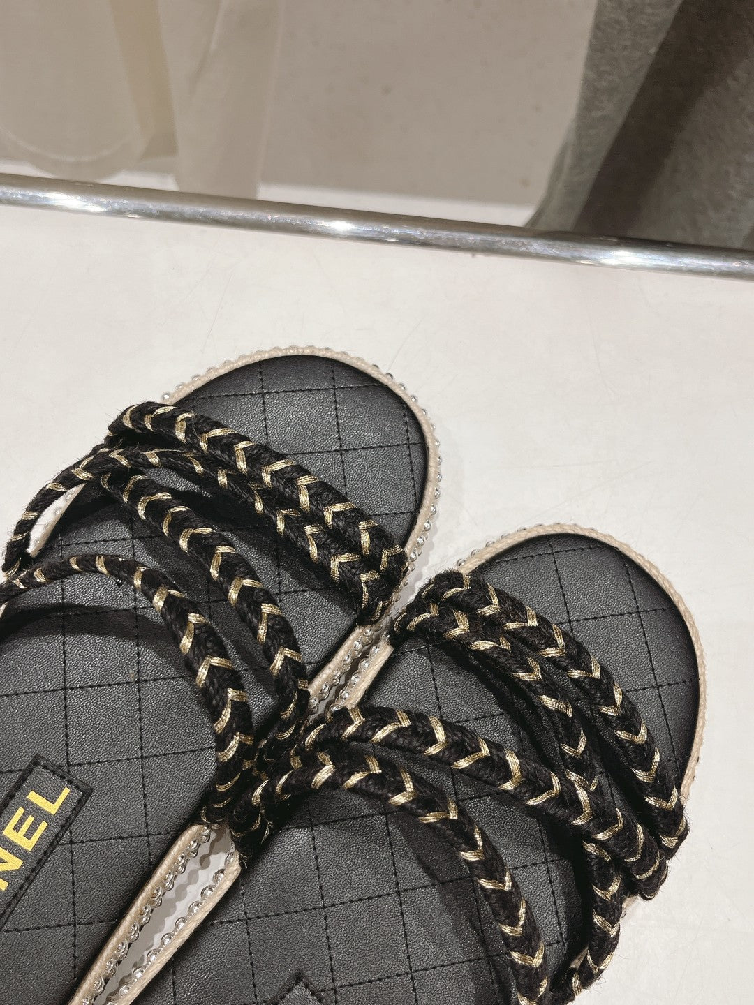 CHANEL WOVEN STRAP SLIPPERS IN BLACK LAMBSKIN